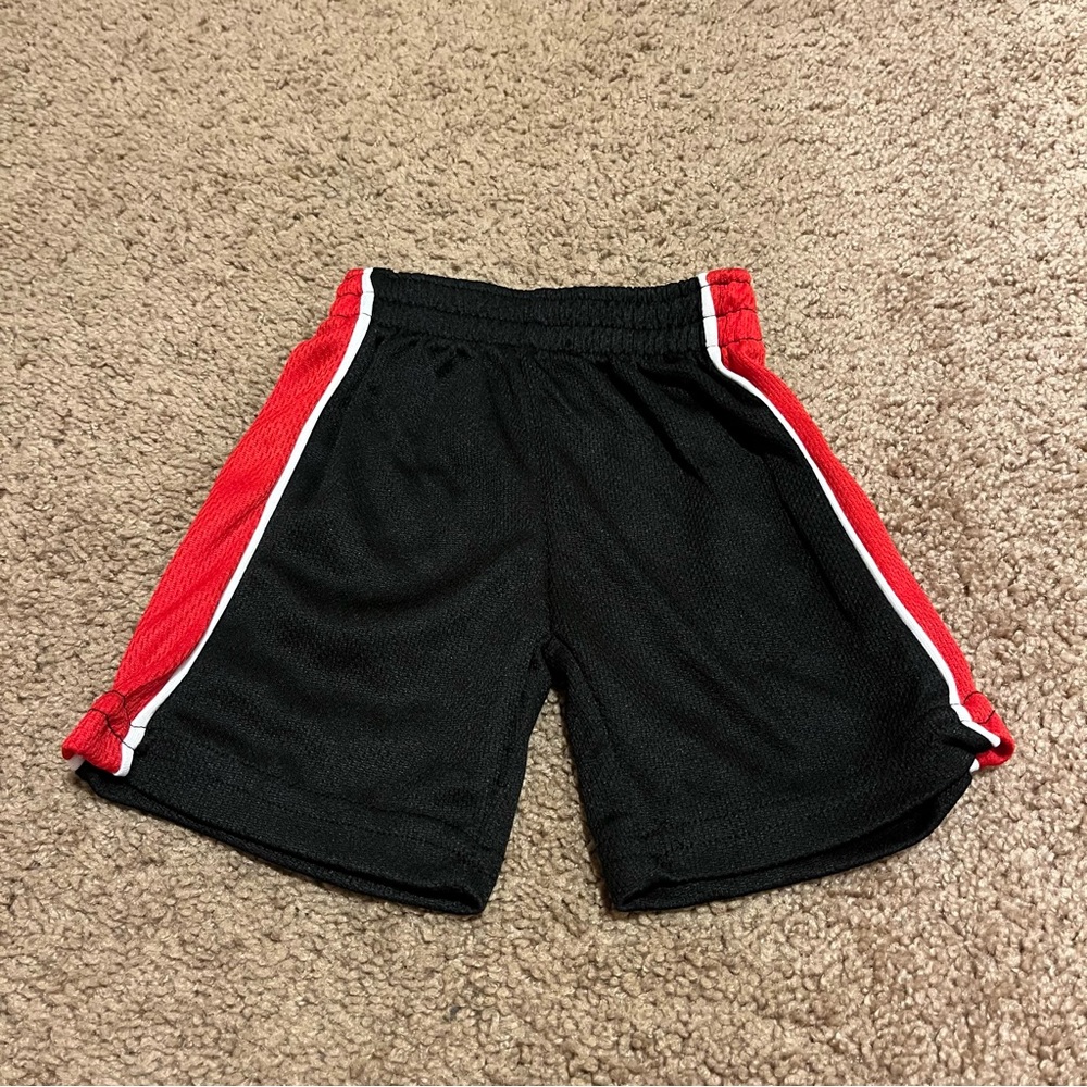 Black, Red, and White Quad Seven Shorts Since 1976